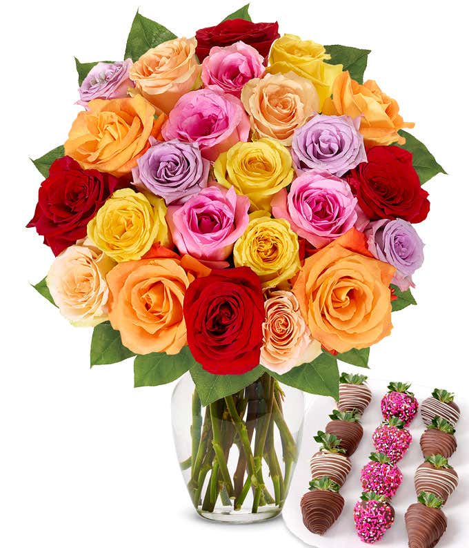 Two dozen rainbow roses with one dozen chocolate covered strawberries decorated with pink sprinkles.