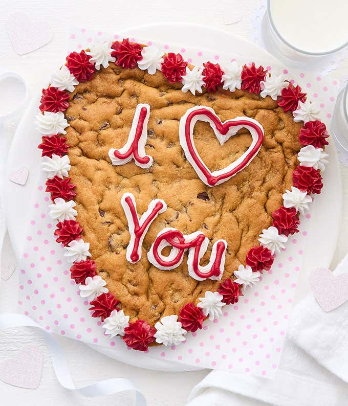 A 9" chocolate chip cookie heart with "I Love You" Written in frosting 